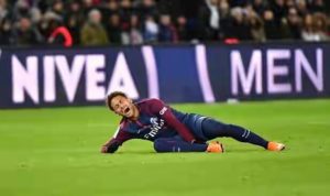 Neymar writhing in pain holds the injured ankle
